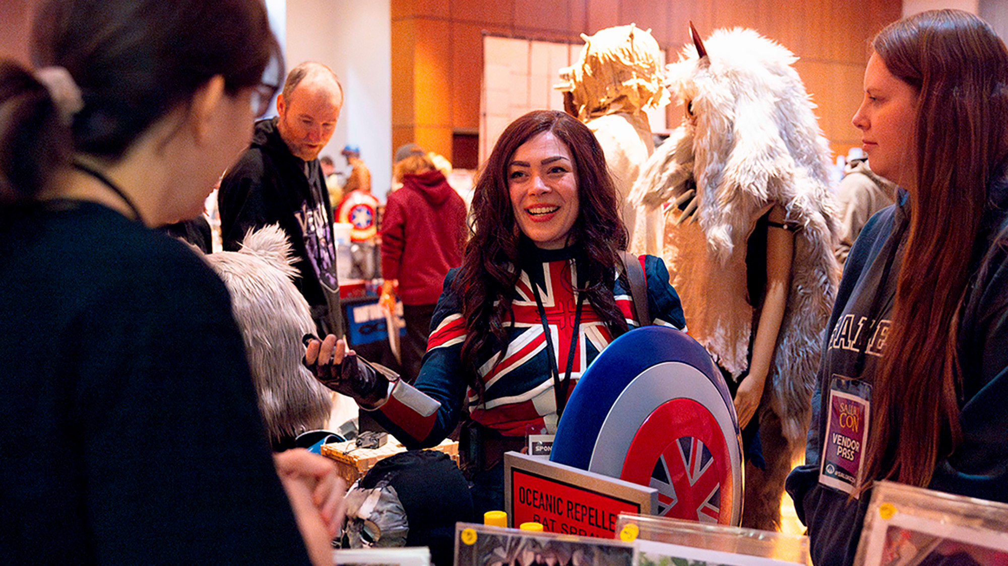 Attendees browse a cosplay and artist booth during Saluki Con